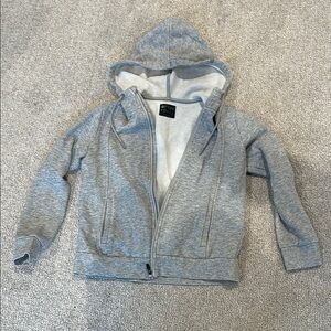 Gray zip-up hoodie with soft cotton-blend fabric and lined hood